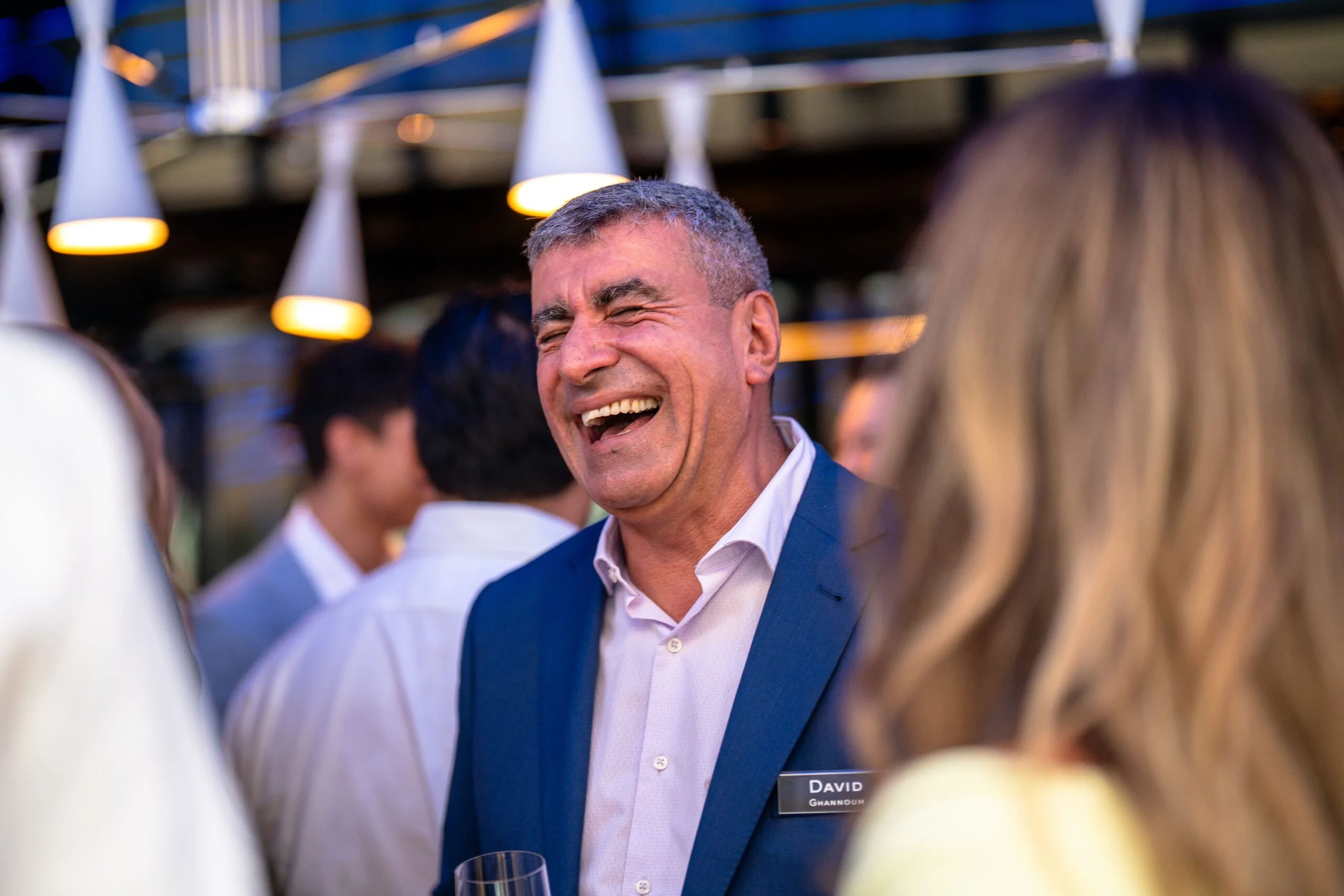 A guest laughing during a corporate social function in Sydney.