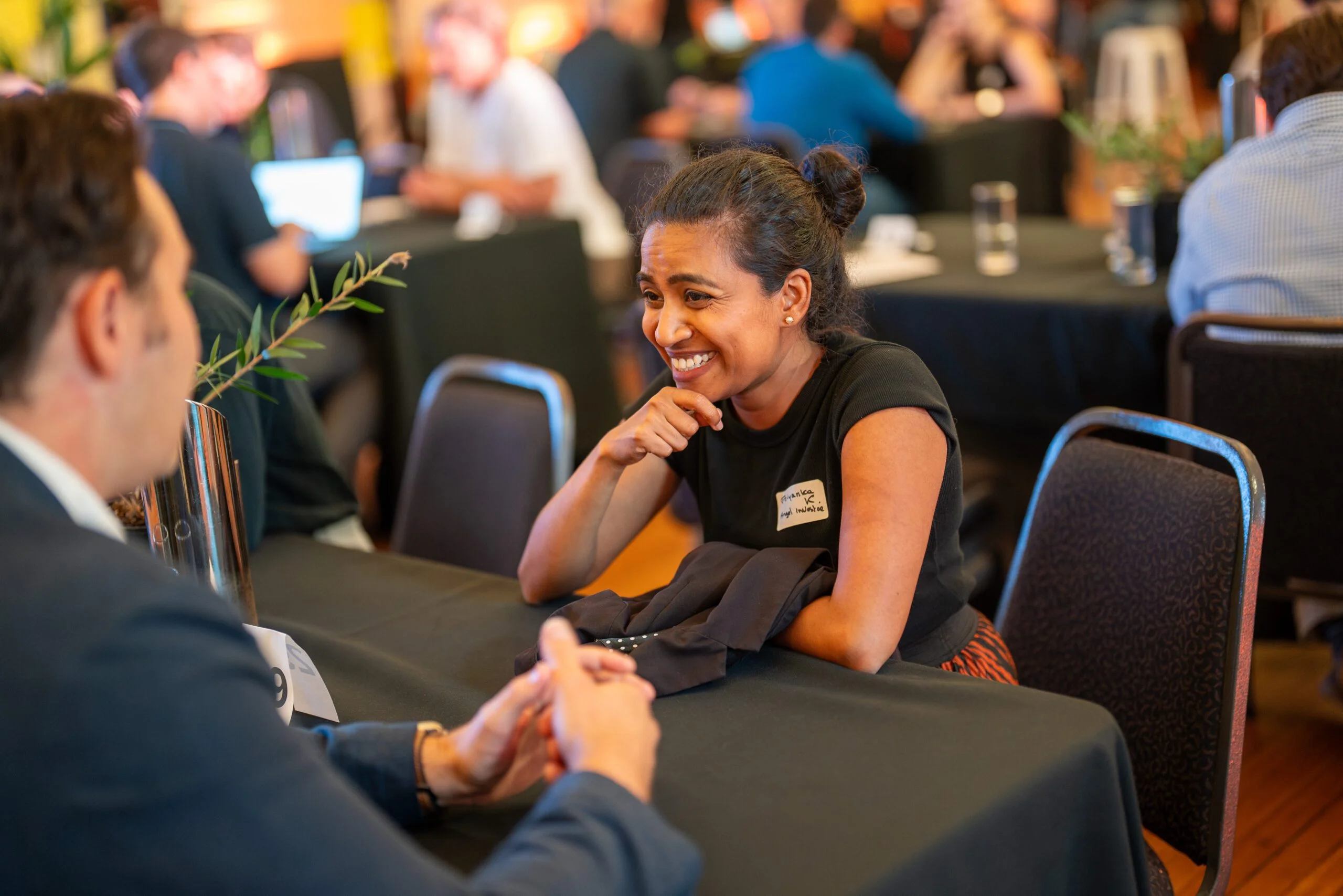 Two attendees networking at a corporate summit event.